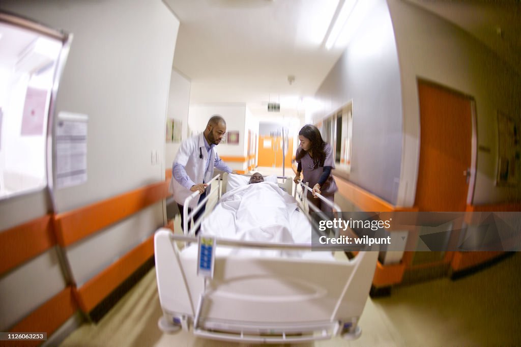 Doctor Rushing Patient In Two Doctors Rushing An Ill Senior Patient To Intensive Care Warm High ...