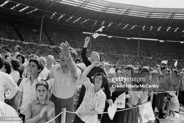 Fans of Pope John Paul II at Crystal Palace during his visit to the UK, London, 30th May 1982.