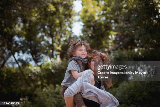 mum and toddler jumping at the park - autism awareness stock pictures, royalty-free photos & images