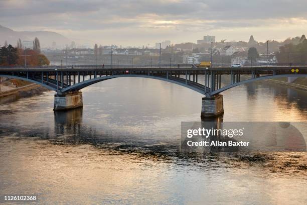 skyline of 'wettsteinbrucke' bridge in basel with river rhine at sunrise - basel port stock pictures, royalty-free photos & images