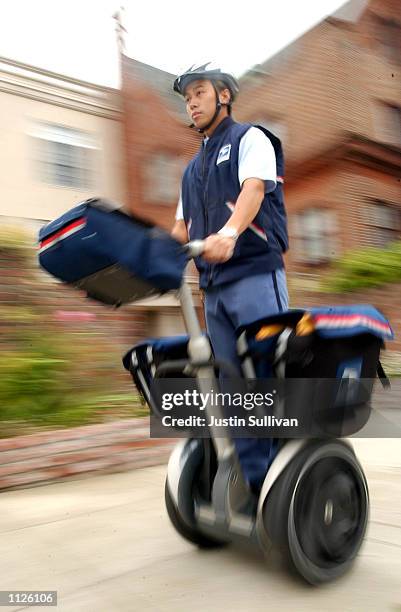 Postal lettercarrier K. Ng rides a Segway Human Transporter on his postal route July 15, 2002 in San Francisco, California. The U.S. Postal service...