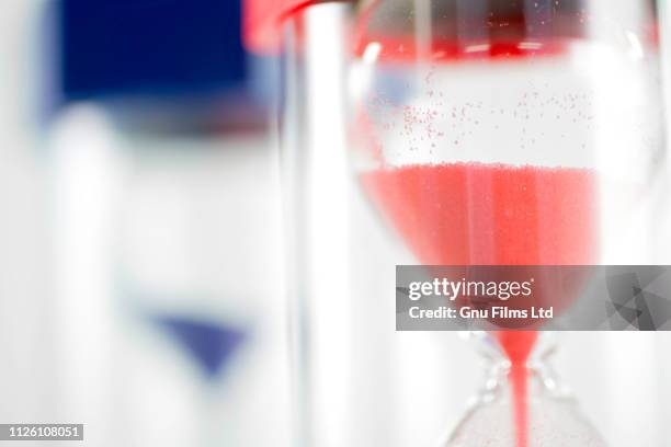 politics concept - red and blue hourglasses filling up with sand - article 50 of the treaty on european union stock pictures, royalty-free photos & images