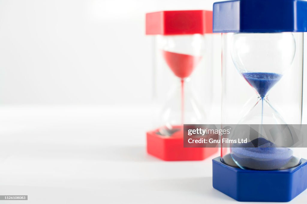 Politics Concept - Red and Blue Hourglasses Filling Up With Sand