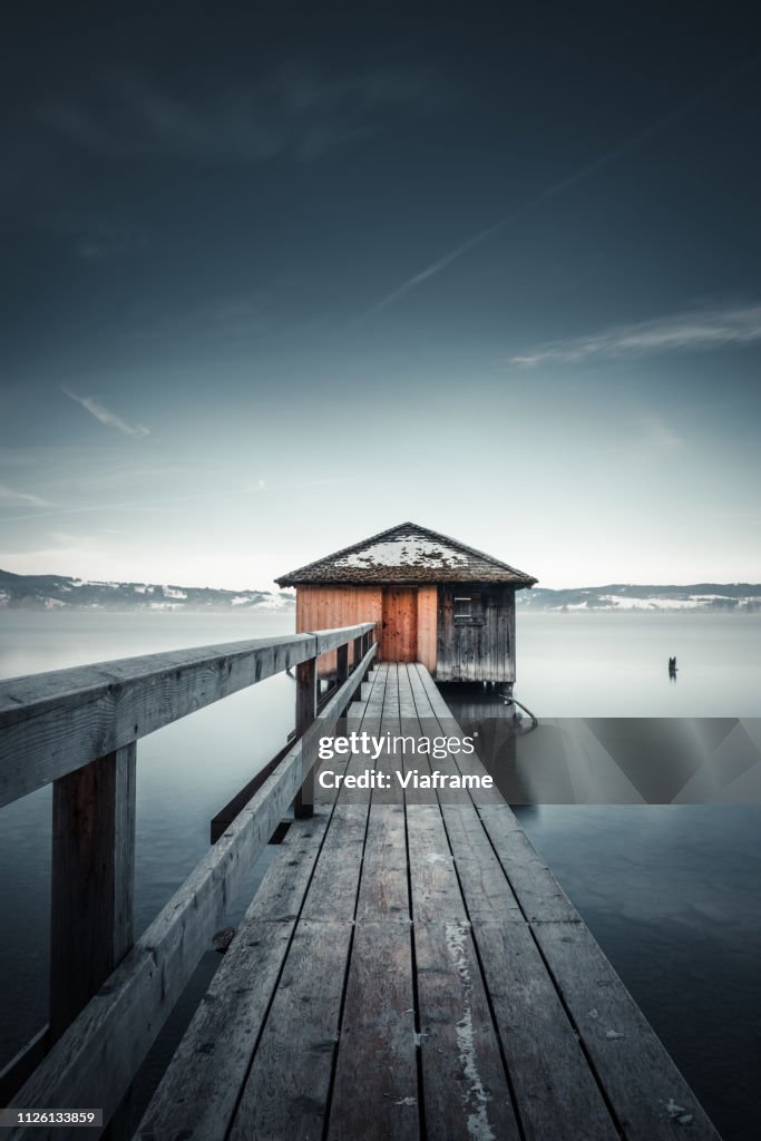 Jetty with house at lake