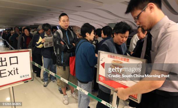 People queuing for free Egg McMuffins outside a McDonald's outlet in Kowloon Bay. 17MAR14