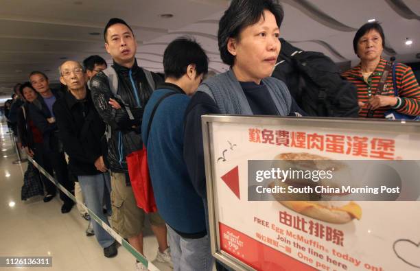 People queuing for free Egg McMuffins outside a McDonald's outlet in Kowloon Bay. 17MAR14