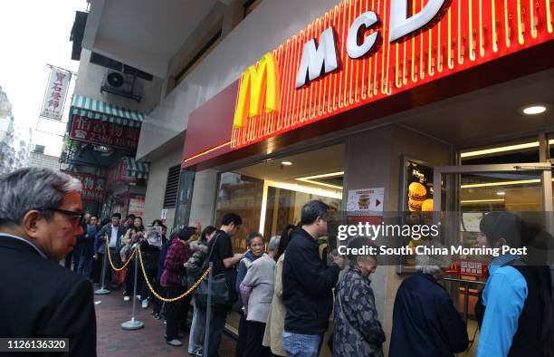 People queuing for free Egg McMuffins outside a McDonald's outlet in Sham Shui Po. 17MAR14