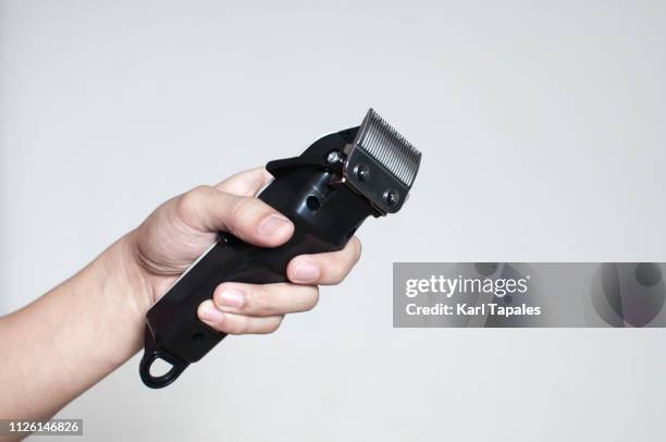 a young person is holding an electric razor - razor stock pictures, royalty-free photos & images