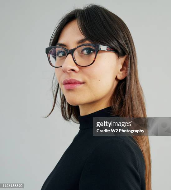 profile portrait of a young woman wearing glasses. - spectacles studio stock pictures, royalty-free photos & images