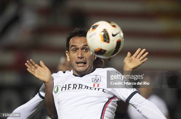 Hebert Arriola of San Martin struggles for the ball with player of Once Caldas during a match as part of the Santander Libertadores Cup 2011 at the...