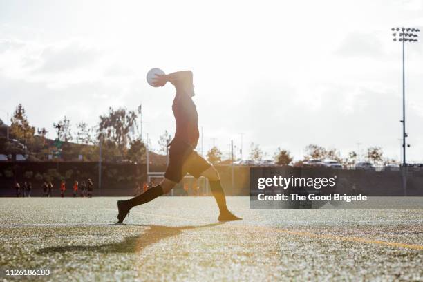 Soccer player throwing ball inbounds