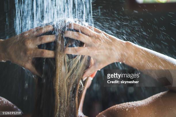 close up of a woman washing her hair while showering in the morning. - women taking showers stock pictures, royalty-free photos & images