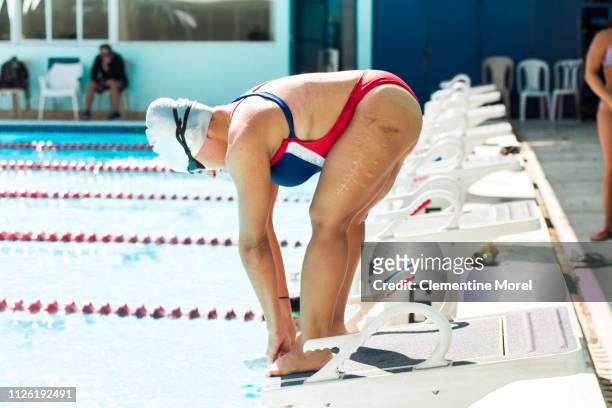 Athlete in position to dive into pool