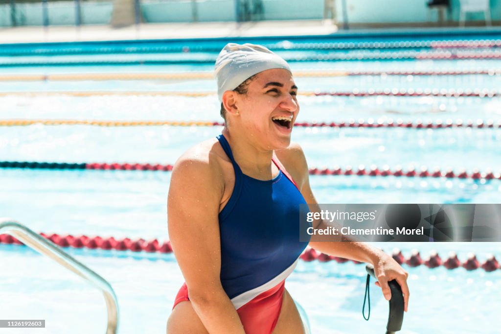 Athlete smiling getting out of the pool