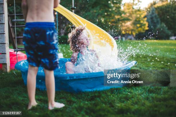 child splashing into a kiddie pool - annie sprinkle stock pictures, royalty-free photos & images