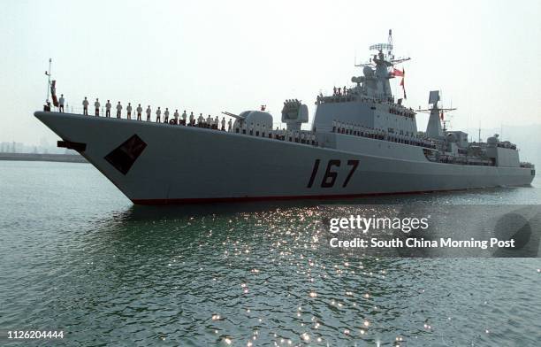 The guided-missile destroyer Shenzhen docked at People's Liberation Army naval headquarters on Stonecutters Island. The ship and its support vessel...