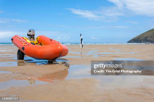an orange rigid inflatable boat (rib) on a beach - surf rescue stock pictures, royalty-free photos & images