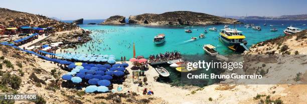 blue lagoon beach in comino island - malta boat stock pictures, royalty-free photos & images