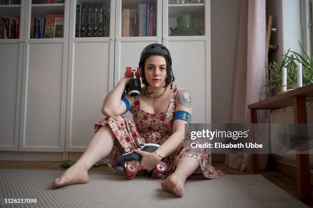 trans woman in roller derby gear at home - roller derby stock pictures, royalty-free photos & images