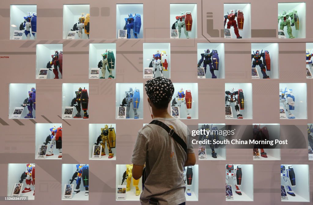 A visitor looks at  Gundam figurines during the 16th Ani-Com and Games at the Hong Kong Convention and Exhibition Center (HKCEC) in Wan Chai. 25JUL14