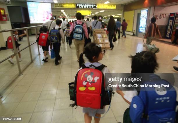 Children of Hong Kong SAR permanent residents living in Shenzhen cross the Shenzhen border checking point on their way to schools in the SAR.