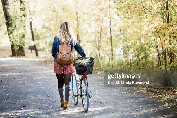 portait of a beautiful young woman during fall season - natural parkland stock pictures, royalty-free photos & images