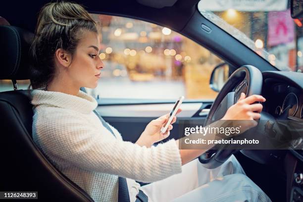 young girl is texting in the traffic jam - distracted driving stock pictures, royalty-free photos & images