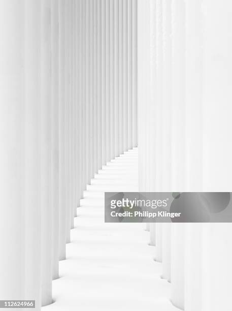 curved path between two rows of white pillars - luxembourg benelux stock-fotos und bilder
