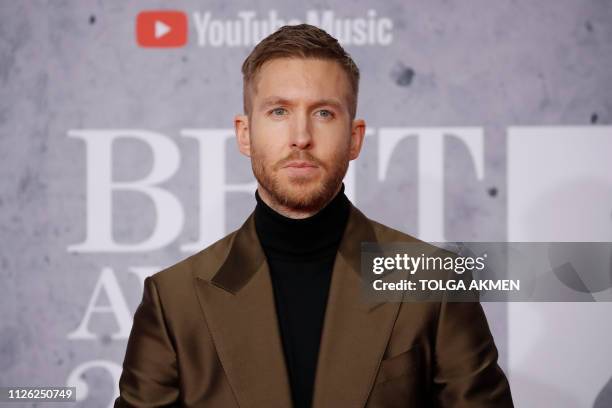 British DJ and musician Calvin Harris poses on the red carpet on arrival for the BRIT Awards 2019 in London on February 20, 2019. / RESTRICTED TO...