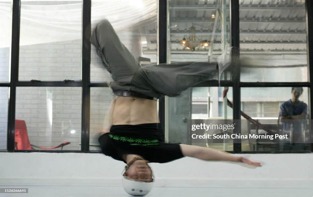 World champion and Korean hip hop dancer Ducky (Kim Duck Hyun), 21, peforms headspin. 30 June 2003