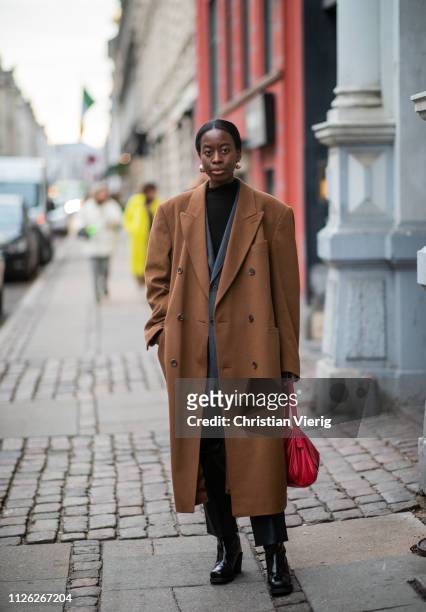 Guest is seen wearing oversied brown coat outside Oh! by Kopenhagen Fur during the Copenhagen Fashion Week Autumn/Winter 2019 - Day 2 on January 30,...