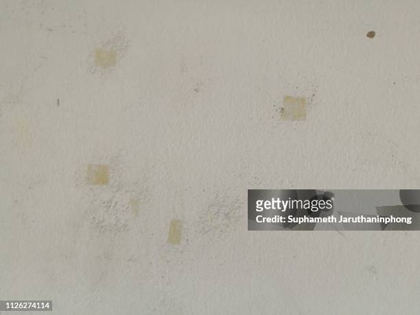 glue and scotch tape stain on white wall. - scotch tape stock-fotos und bilder