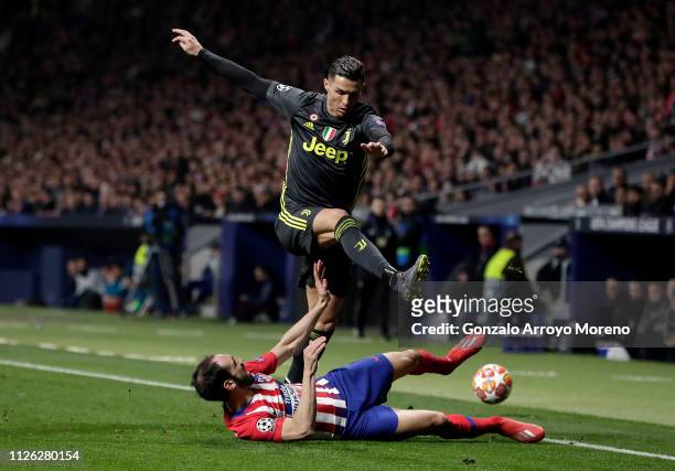 Cristiano Ronaldo of Juventus is challenged by Juanfran of Atletico Madrid during the UEFA Champions League Round of 16 First Leg match between Club...