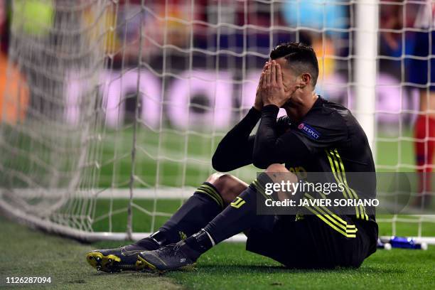 Juventus' Portuguese forward Cristiano Ronaldo covers his face during the UEFA Champions League round of 16 first leg football match between Club...