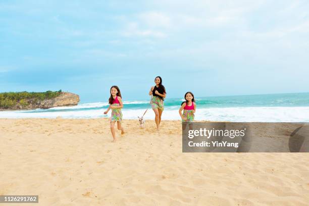 hawaiian family mother and children on beach of kauai - hawaii vacation and parent and teenager stock pictures, royalty-free photos & images