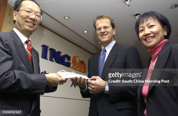Ing Asia/Pacific presents a cheque to Operation Santa Claus. Pictured are Cheng Man-kwong, Country Manager for Ing Asia/Pacific, Bryan Curtis, Head...