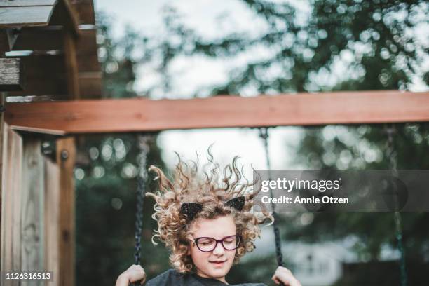 girl with wild hair swinging - cat costume stock pictures, royalty-free photos & images