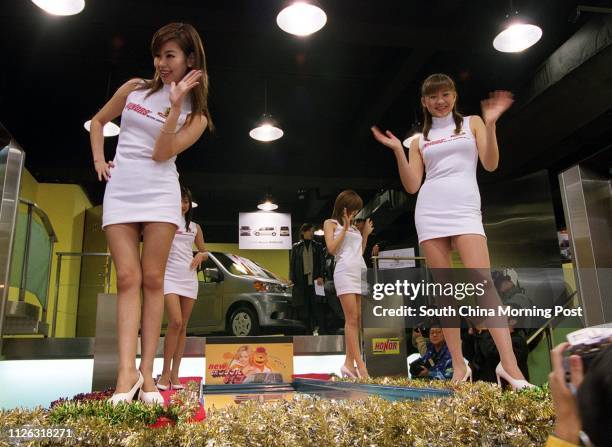 ACTRESSes pose for photographers during the OPENING OF Honor Motors JAPAN MINI CARS SHOWROOM in WAN CHAI.