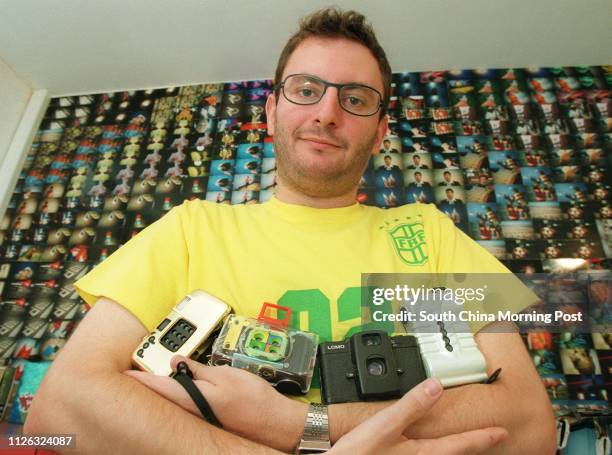 Arnault Castel of Lomographic Society Asia pictured with various LOMO cameras in his office in Central.