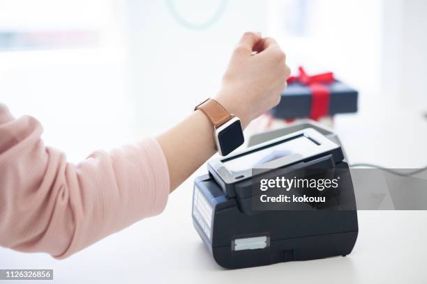 electronic settlement with smart watch - smart watch stock pictures, royalty-free photos & images