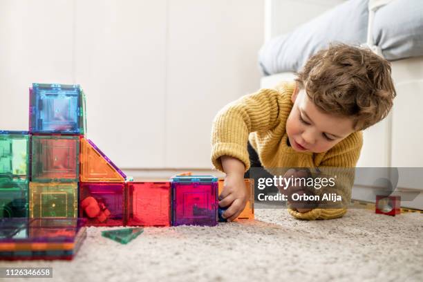 boy playing with building blocks - kids room stock pictures, royalty-free photos & images