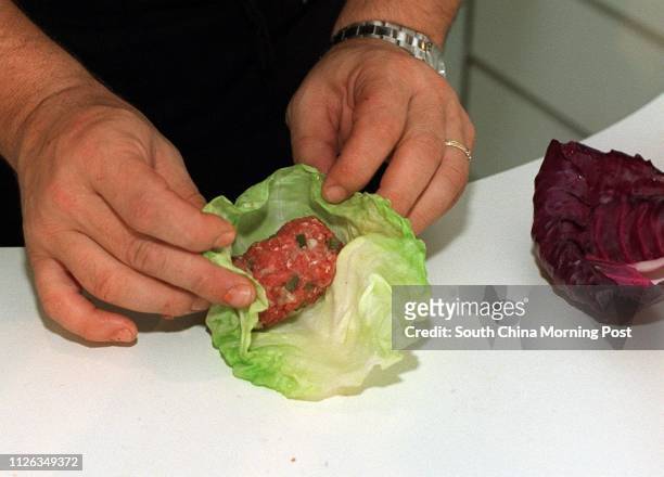 Adam Levin, chef of the Bostonian restaurant at the Great Eagle Hotel, preparing his dish, &quot;Stuffed Cabbage with Sweet and Sour Tomatoes&quot;,...