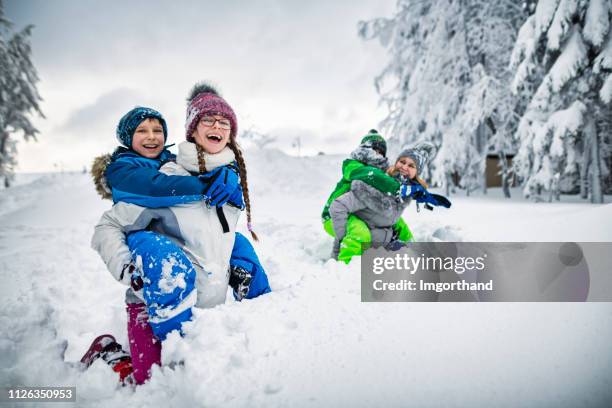 happy family playing in deep snow - kid in deep snow stock pictures, royalty-free photos & images