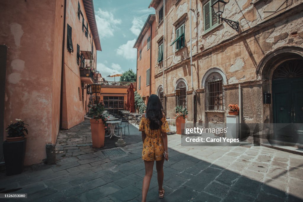 Young woman walking in Pisa street