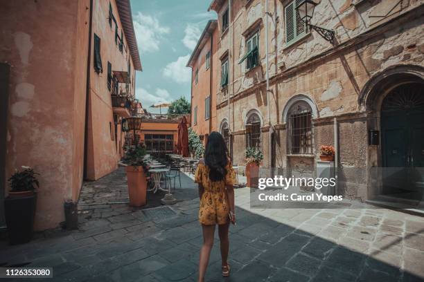 young woman walking in pisa street - pisa italy stock pictures, royalty-free photos & images