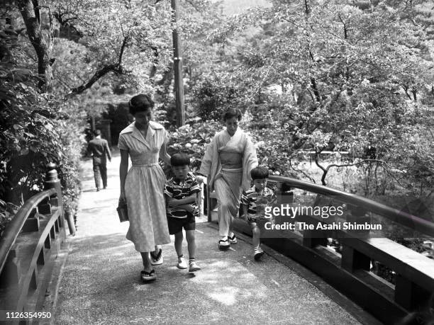 Shinzo Abe , grandson of Prime Minister Nobusuke Kishi, walks with Kishi's wife Ryoko , elder brother Hironobu and mother Yoko on July 7, 1957 in...