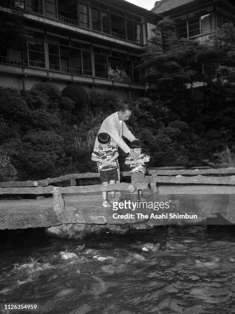Prime Minister Nobusuke Kishi strolls with grandsons Hironobu and Shinzo on July 7, 1957 in Hakone, Kanagawa, Japan.
