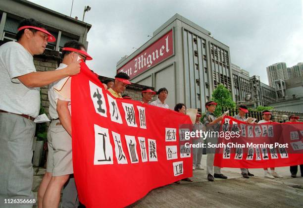 Sacked employees from San Miguel Brewery's sales and production departments petition at San Miguel's Sham Tseng plant to try to persuade managers to...