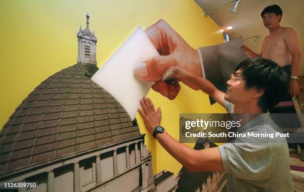 The voting hand, which has characterised the campaign to encourage people to cast their ballots, is added to a model at the election press centre in...