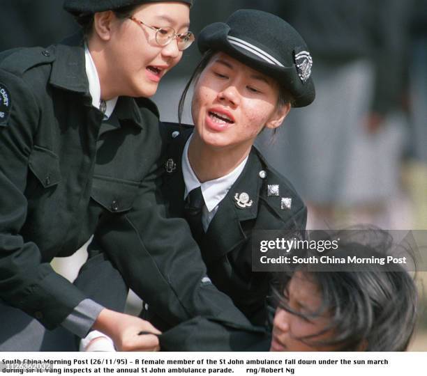 Female member of the St John ambulance fall down under the sun march during Sir Ti Liang Yang inspects at the annual St John amblulance parade 26 Nov...